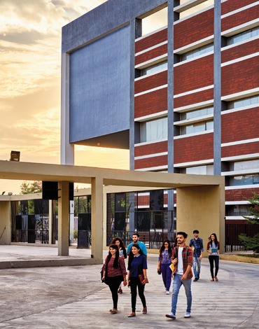 Students walking through the Shanti Business School campus